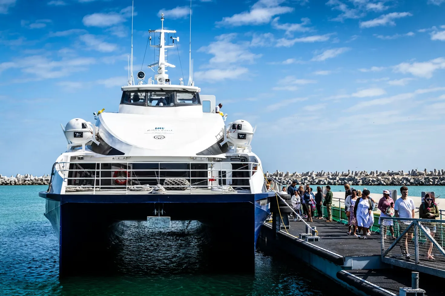 Survey vessel berthed at the wharf with passengers boarding