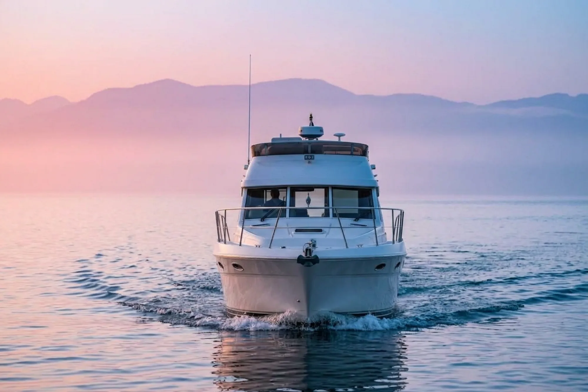 Marine survey vessel underway at sunset